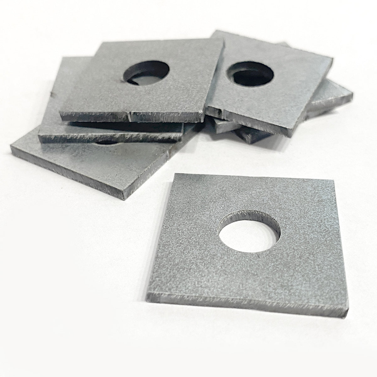 Square Washers on a pile with a white background